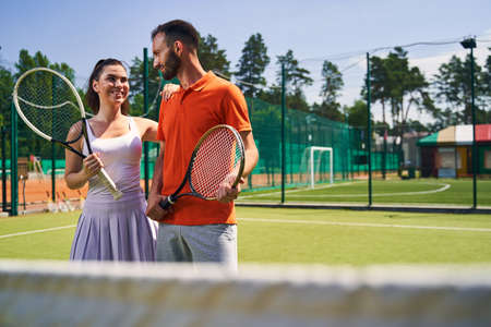 Female athlete leaning on her partner shoulder before the gameの写真素材
