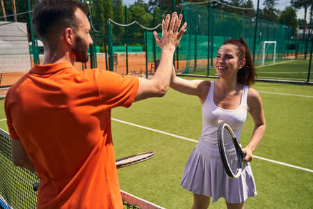 Joyful charming sportswoman greeting her opponent before the matchの写真素材