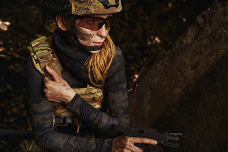 Serious woman holding hand firearms for shooting