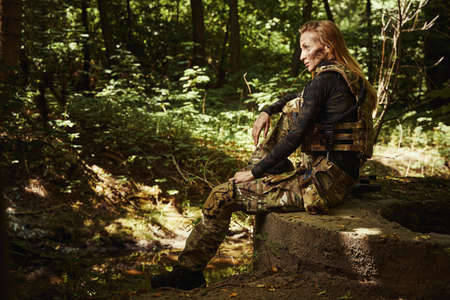 Smiling soldier training physical skills in woodの写真素材