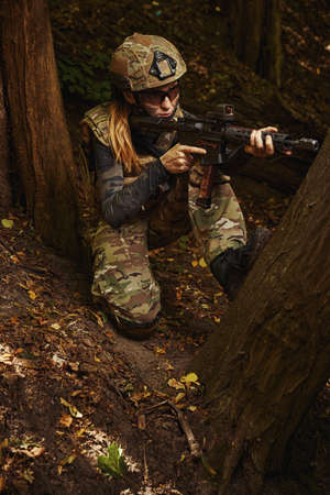 Female person disguising in trees to achieve goalの写真素材