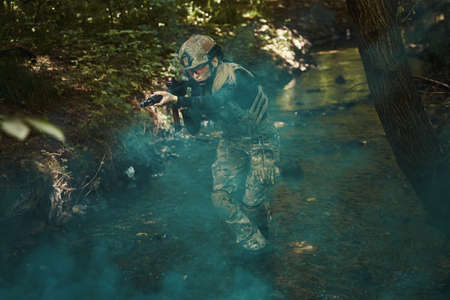 Serious woman in uniform aiming at targetの写真素材