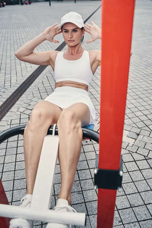 Sit-ups performed by a sportswoman on outside gym machine