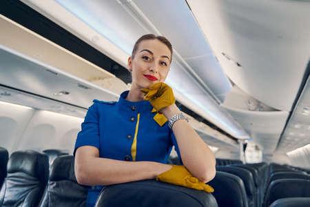 Calm lovely stylish stewardess in uniform posing for the cameraの写真素材