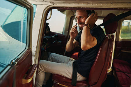 Positive delighted male person testing professional equipmentの写真素材