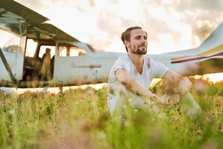 Relaxed bearded male being deep in his thoughts