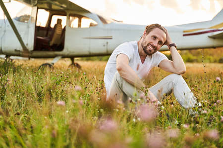 Positive delighted male model posing on cameraの写真素材