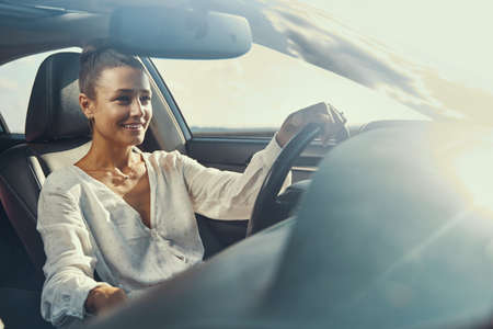 Female having a car drive on sunny day