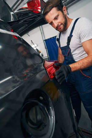 Man adjusting taillight on an automobileの写真素材
