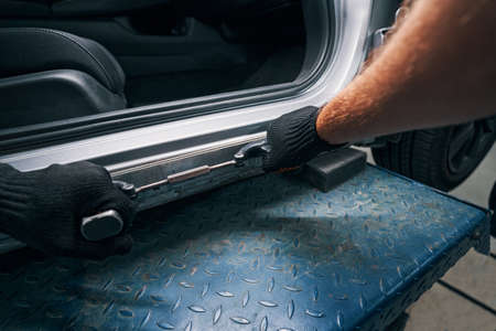 Straightening of car frame surface with peening instrumentの写真素材