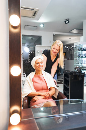 Positive delighted client looking at her reflectionの写真素材