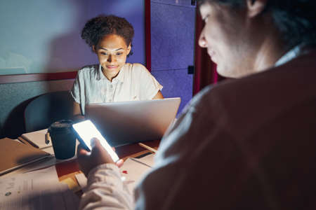 Male and female persons working together on workplaceの写真素材