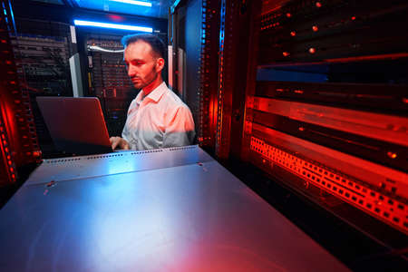 Data center administrator inspecting server rack softwareの写真素材