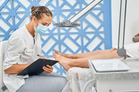 Close up of serious woman making notesの写真素材