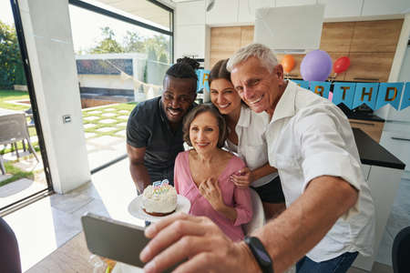 People looking at smartphone with charming smile