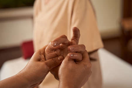 Caucasian spa client getting Thai hand massageの写真素材