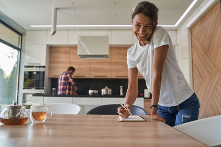 Pretty elegant Caucasian lady having a conversation on a cell phone in home apartmentsの写真素材
