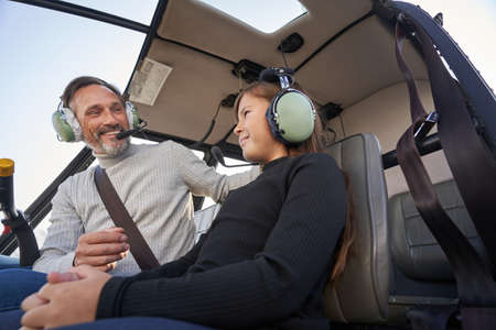 Joyous dad taking his lovely daughter on an aerial tripの写真素材