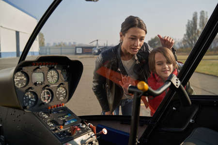Curious child and his mother studying airplane mechanismsの写真素材
