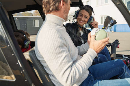 Delighted lady and her partner preparing to fly a helicopterの写真素材