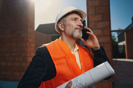 Professional architect wearing protective equipment in the construction siteの写真素材