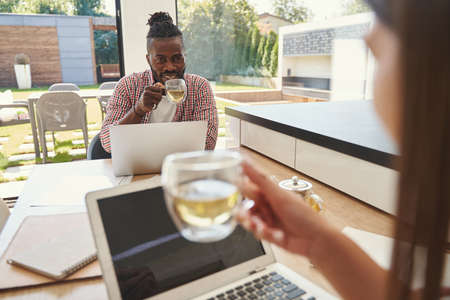 Man enjoying tea break with his female colleague