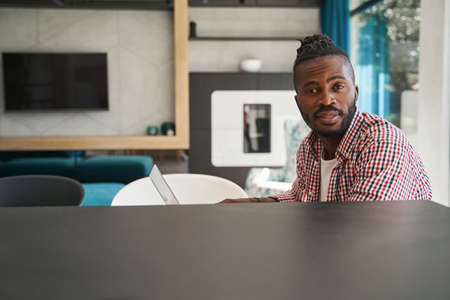 Tranquil African American male freelancer sitting at laptopの写真素材