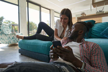 Man with cellphone staring at joyful lady