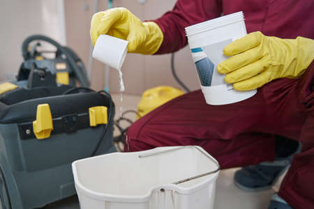 Experienced worker getting equipment ready for cleaningの写真素材