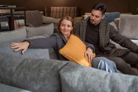 Young Caucasian couple shopping for new couch