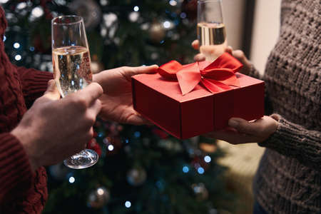 Woman taking gift box on Christmas eveの写真素材