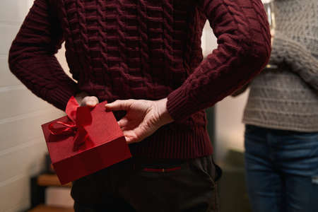 Man going to congratulate his girlfriend with Christmas giftの写真素材