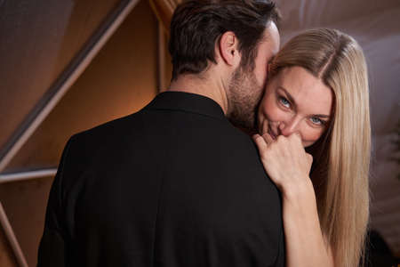 Woman shyly smiling to camera during dance with manの写真素材