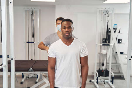 Patient having his spine examined by experienced physiotherapist