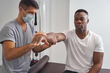 Young man having his muscle strength assessed