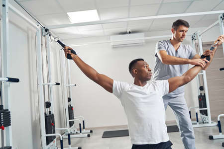 Man undergoing physiotherapy session with professional physiotherapistの写真素材