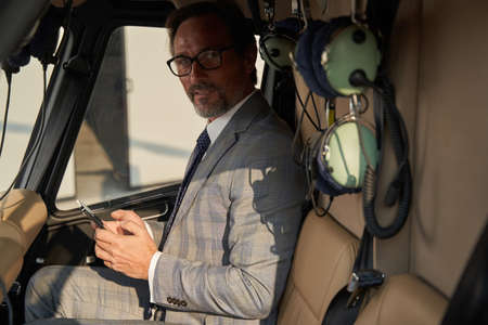 Tranquil elegant male passenger sitting in chopper