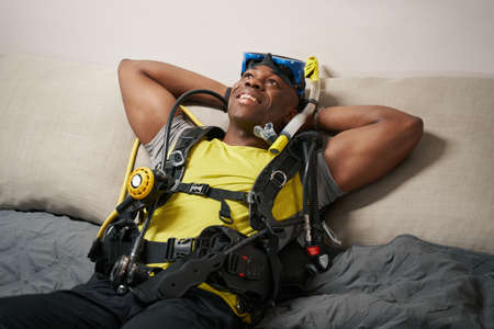 Joyful man enjoying rest in scuba diving suitの写真素材