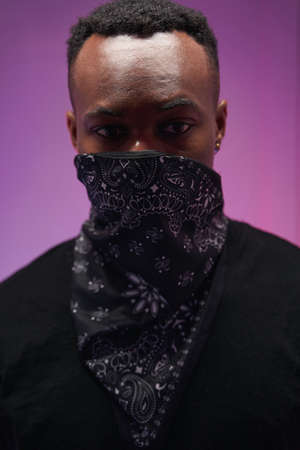 Multiracial man posing in neck face mask