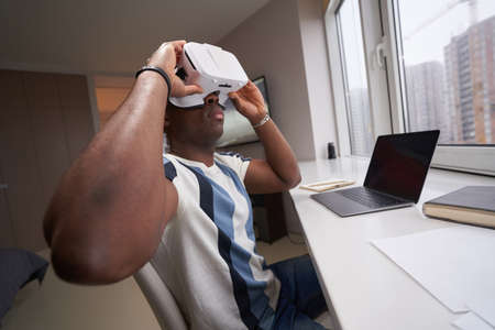 Male at home looking through augmented reality headset