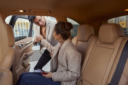 Gallant man helping woman out of car