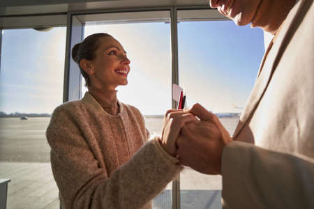 Cheerful female with tickets smiling at her manの写真素材