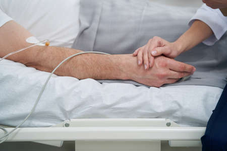 Attending doctor examining patient during medical procedureの写真素材