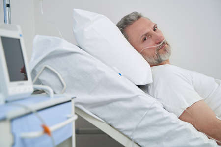 Patient undergoing oxygen therapy in healthcare facilityの写真素材