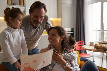 Family checking the painting in hands of mother