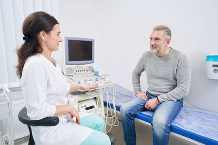 Male patient looking at sonographer before ultrasound scan