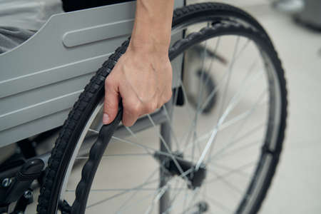 Person with disability using manually-propelled chair indoorsの写真素材
