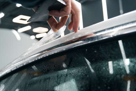 Professional detailer hand applying auto body coatingの写真素材