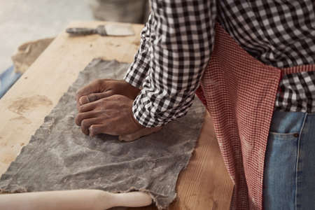 African American ceramist working in his studioの写真素材