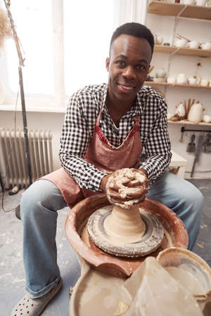 Joyous potter posing for camera at workの写真素材